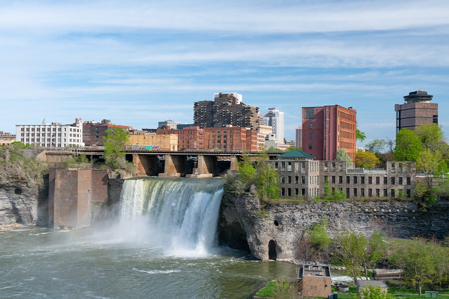Contact - High Falls of Rochester New York in Front of a City Skyline Surrounded by Trees